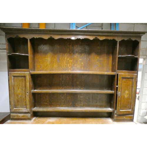 555 - Victorian oak dresser, the top section with open Delft rack flanked by open shelving, above cupboard... 