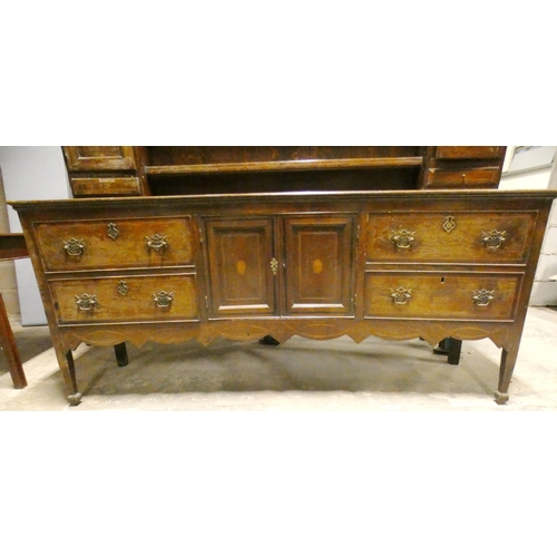 555 - Victorian oak dresser, the top section with open Delft rack flanked by open shelving, above cupboard... 