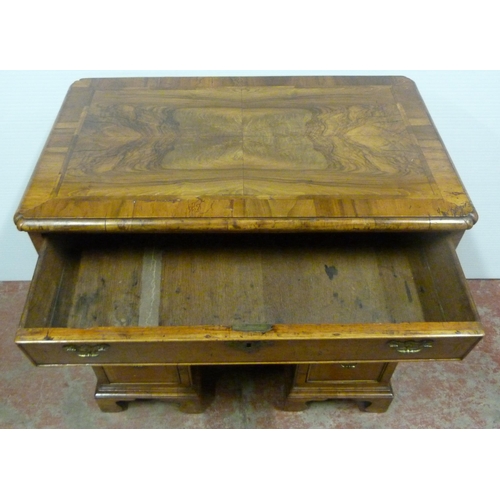 560 - George III walnut and feather banded kneehole desk with a frieze drawer above indented central cupbo... 