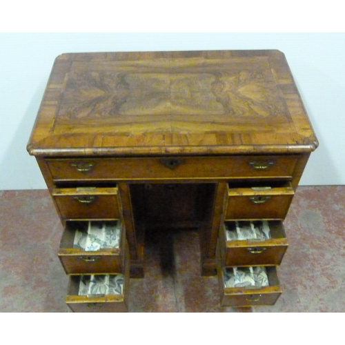 560 - George III walnut and feather banded kneehole desk with a frieze drawer above indented central cupbo... 