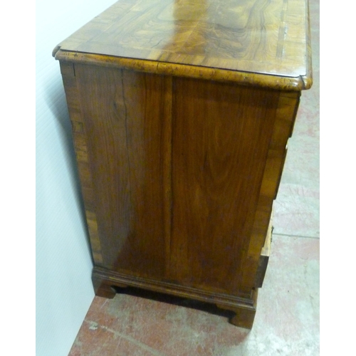 560 - George III walnut and feather banded kneehole desk with a frieze drawer above indented central cupbo... 