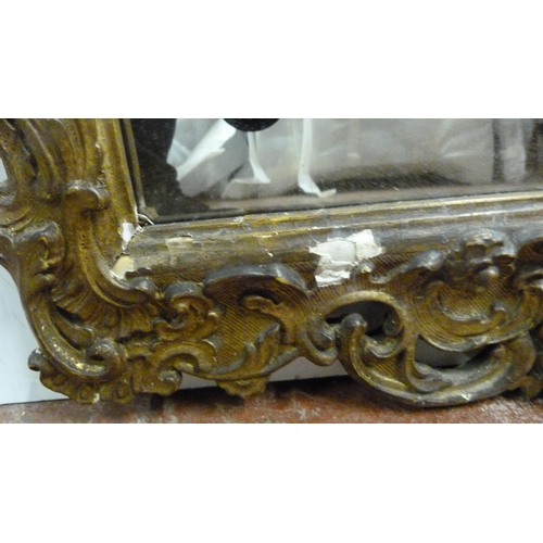 503 - Rococo-style giltwood and gesso wall mirror, 19th century, the frame with all over scrolls, plate gl... 