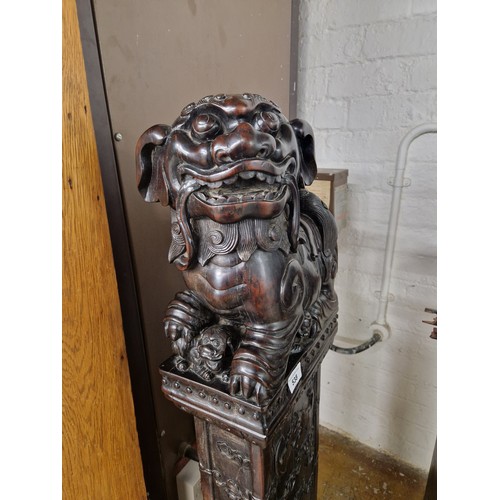 538 - Pair of carved hardwood Chinese foo dogs.128cm high