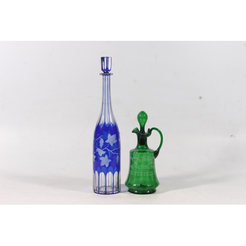 128 - Edwardian blue glass overlay cut to clear decanter and a similar period green glass enamelled jug (2... 