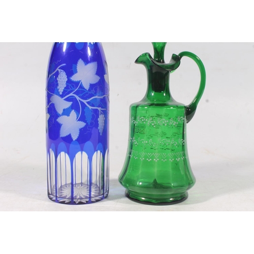 128 - Edwardian blue glass overlay cut to clear decanter and a similar period green glass enamelled jug (2... 