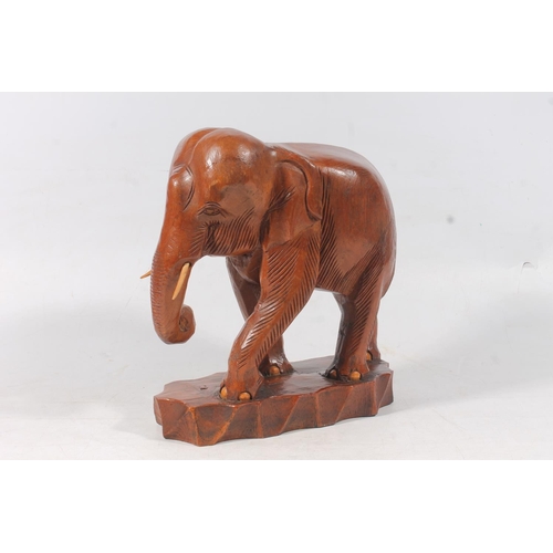 136 - Carved hardwood elephant figure, H31cm.