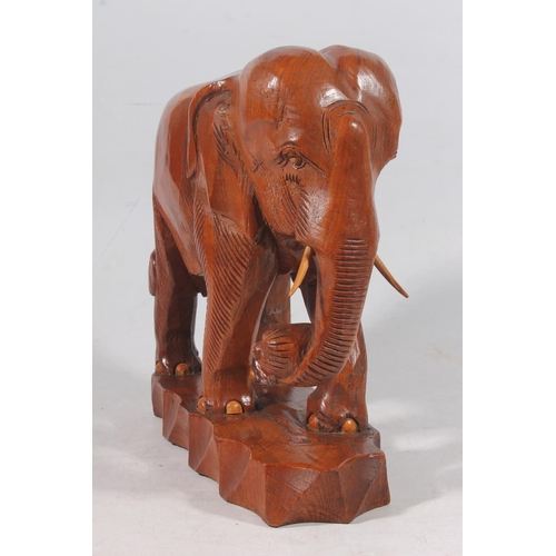 136 - Carved hardwood elephant figure, H31cm.