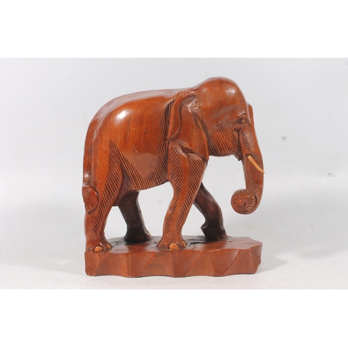 136 - Carved hardwood elephant figure, H31cm.