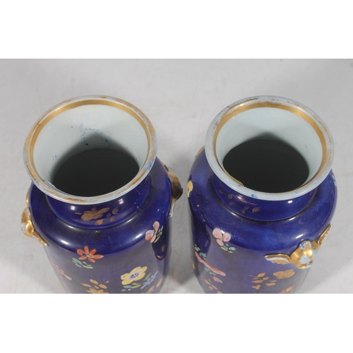 192 - Pair of European porcelain vases, the deep blue ground decorated with flowers, 15cm tall.