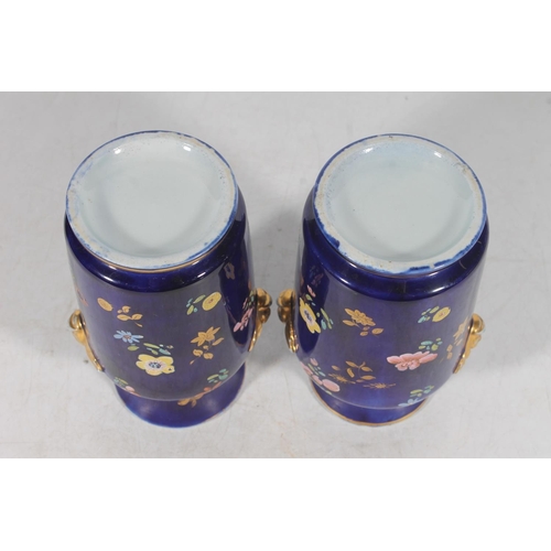 192 - Pair of European porcelain vases, the deep blue ground decorated with flowers, 15cm tall.