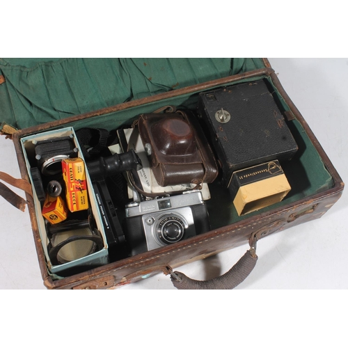 69 - Small leather case containing vintage cameras and accessories.