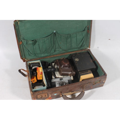 69 - Small leather case containing vintage cameras and accessories.