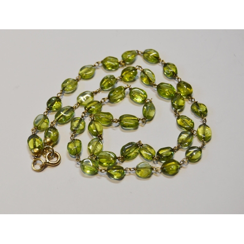 244 - 9ct gold lady's necklace set with multiple peridot-coloured green stones, stamped '375', 20cm, 9.1g ... 