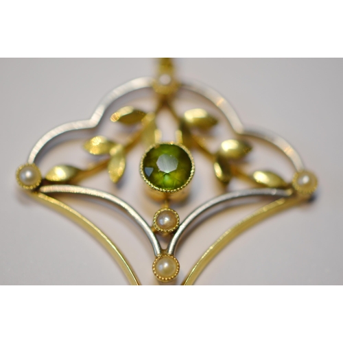 246 - Art Nouveau 15ct gold peridot and seed pearl lady's pendant set with a central cabochon peridot, wit... 