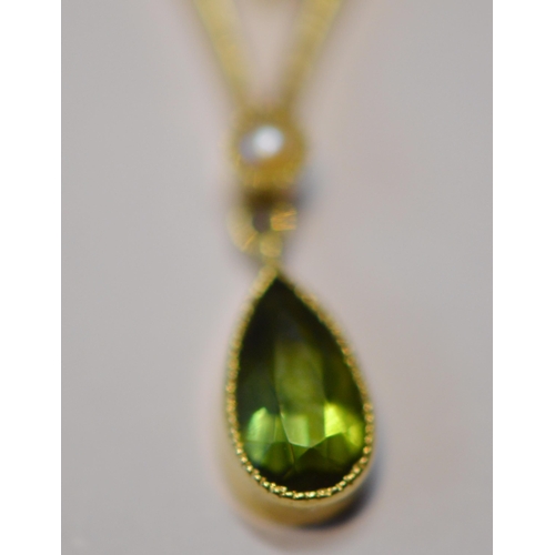 246 - Art Nouveau 15ct gold peridot and seed pearl lady's pendant set with a central cabochon peridot, wit... 