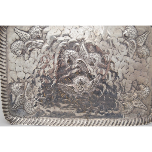 138 - Victorian hammered silver rectangular toilet tray with moulded border, decorated with repoussé winge... 