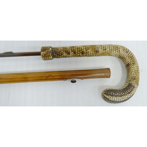 401 - Bamboo sword stick, c. early 20th century, with snakeskin-style handle, push button release to the s... 