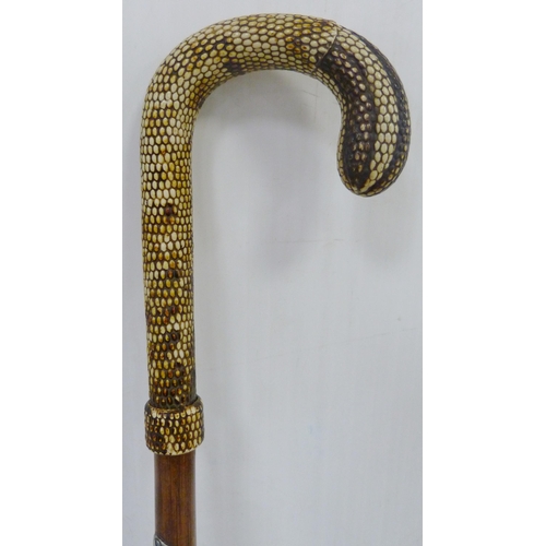 401 - Bamboo sword stick, c. early 20th century, with snakeskin-style handle, push button release to the s... 