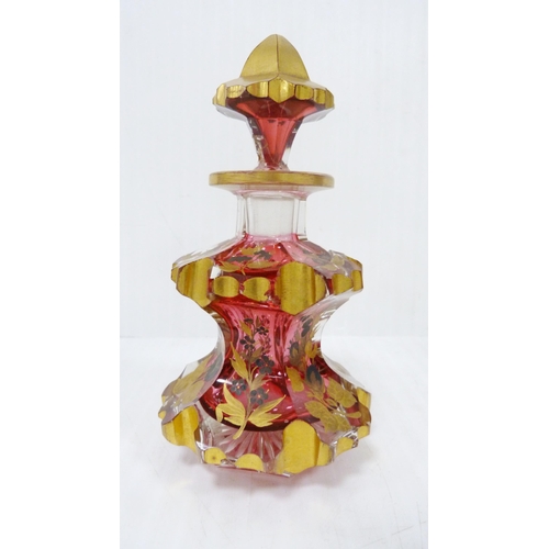 338 - Pair of Bohemian cranberry and gilded glass toilet bottles and stoppers of faceted form, with gilded... 