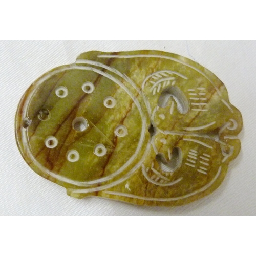 365 - Four Chinese-style jade-coloured pendants to include a disc and figure example, largest 6cm diameter... 