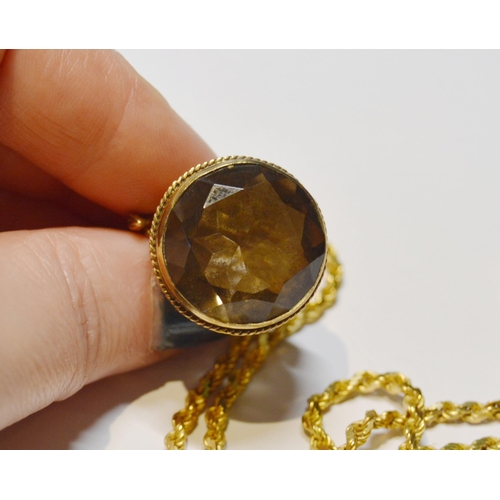 252 - 9ct gold smoky quartz fob with entwined horses to the surmount, the faceted quartz measuring approxi... 