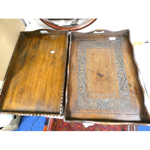 153 - Two oak trays and a mahogany oval wall mirror.