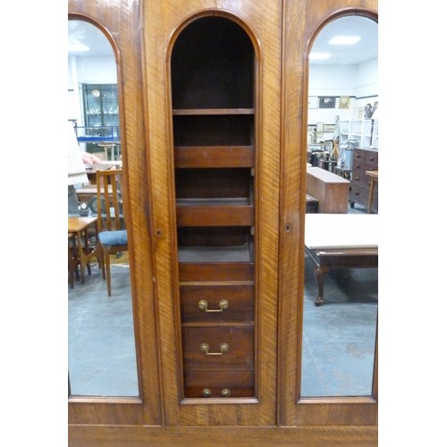 562 - Victorian mahogany wardrobe, the shaped cornice above two mirrored doors enclosing fitted drawers an... 