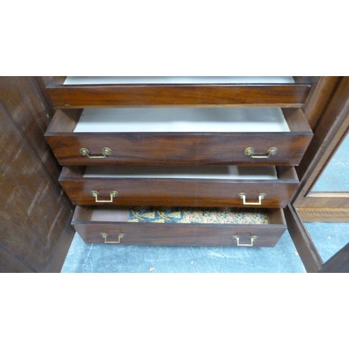 562 - Victorian mahogany wardrobe, the shaped cornice above two mirrored doors enclosing fitted drawers an... 