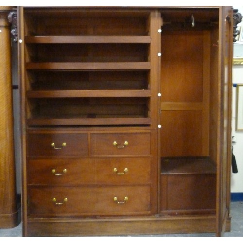 563 - Victorian mahogany three-door wardrobe, the moulded cornice above three doors, central pivot door, e... 