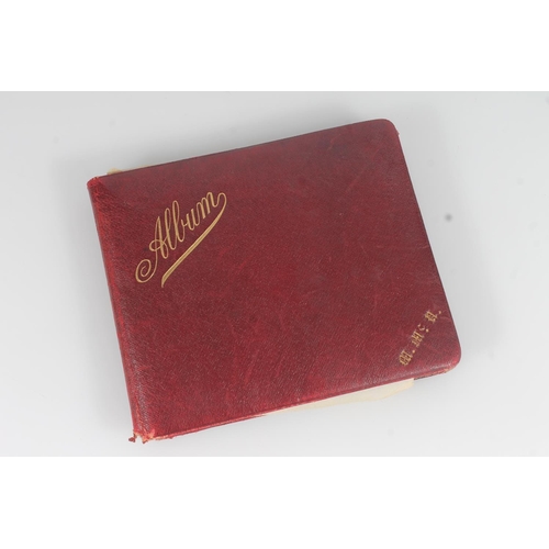 21 - Edwardian guest book, the maroon leather cover opening to reveal pages of autographs, poems, signatu... 