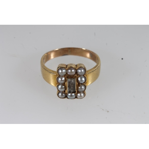 22 - Early 20thC yellow metal and seed pearl mourning ring, the central glazed panel enclosing woven hair... 