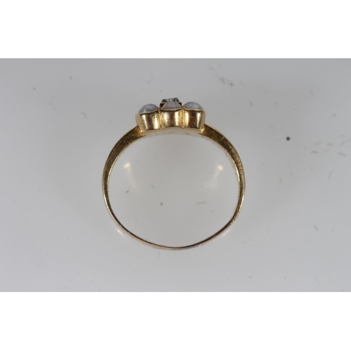 22 - Early 20thC yellow metal and seed pearl mourning ring, the central glazed panel enclosing woven hair... 