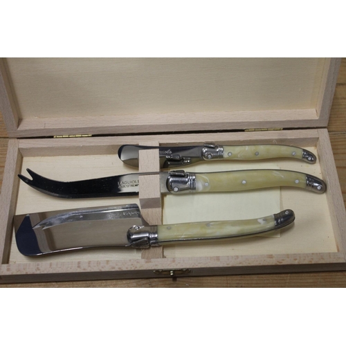 240 - Laguiole French silver plated servers and a hallmarked Edinburgh silver spoon.