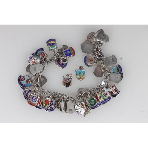 25 - Silver and enamel souvenir charm bracelet, the charms decorated with British and European civic hera... 