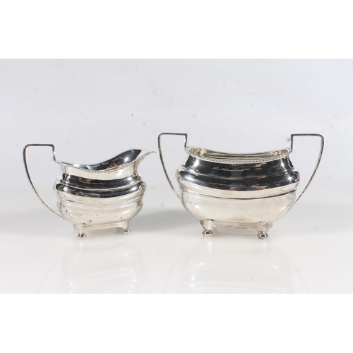 44 - Geo. V three piece silver tea service, the reeded rims over a ribbed body raised on bun feet, the te... 