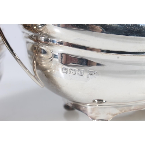 44 - Geo. V three piece silver tea service, the reeded rims over a ribbed body raised on bun feet, the te... 