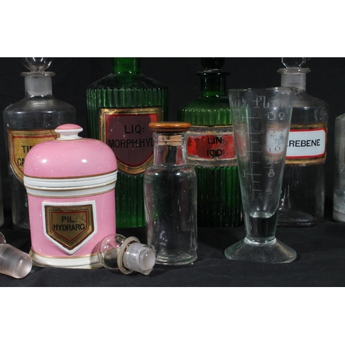 92 - Early 20thC glass apothecary bottles and a Victorian pottery drug jar.