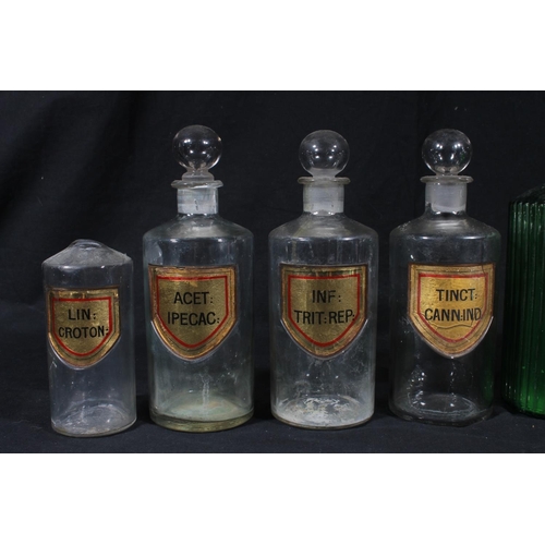 92 - Early 20thC glass apothecary bottles and a Victorian pottery drug jar.