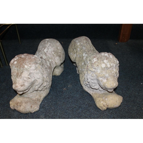 30 - Pair of composite stoneware garden recumbent lion statues, max L55cm.