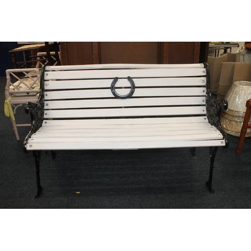 31 - Cast iron and wooden slat garden bench, the pierced wrought iron sides with foliate scroll decoratio... 