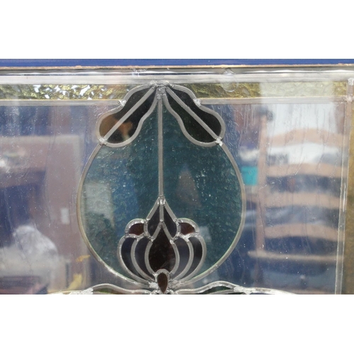 84 - Stained glass panel with central flower decoration, 95cm x 65cm.