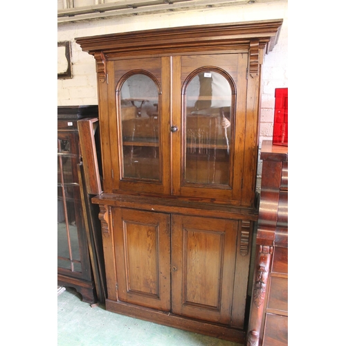 566 - Stained pine bookcase, H189cm.