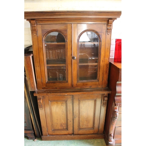 566 - Stained pine bookcase, H189cm.