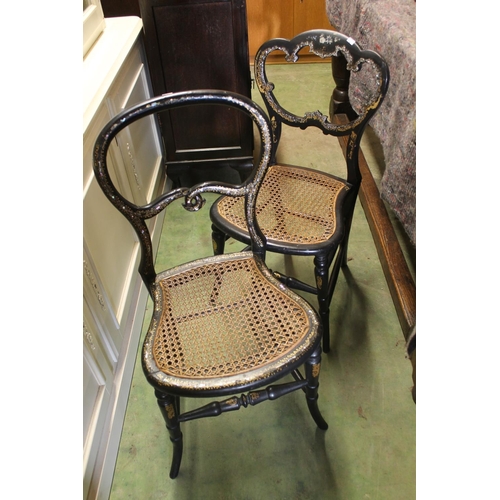 596 - Two similar ebonised Victorian chairs with gilt and mother of pearl decoration.