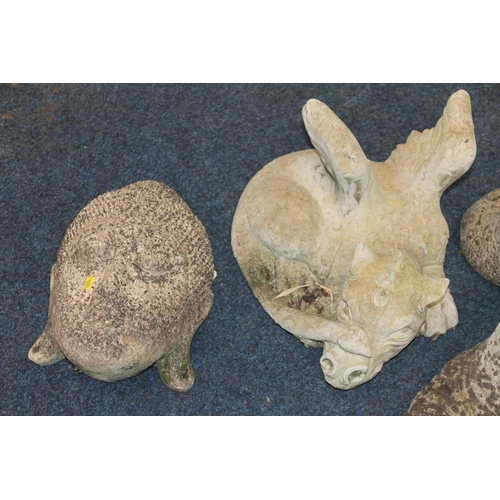 657 - Four Garden stoneware ornaments incl. dragon, Buddha and Easter Island head