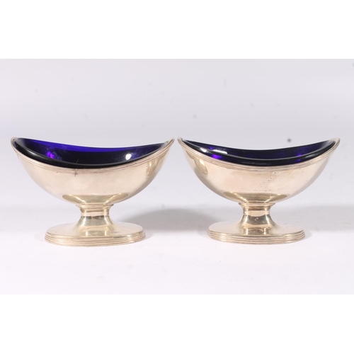 11 - Four Geo. IV silver navette shape salts, with reeded border and foot with fitted blue glass liners, ... 