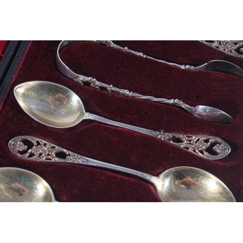 12 - Set of six Victorian silver teaspoons with matching sugar tongs, decorated in pierced foliate scroll... 