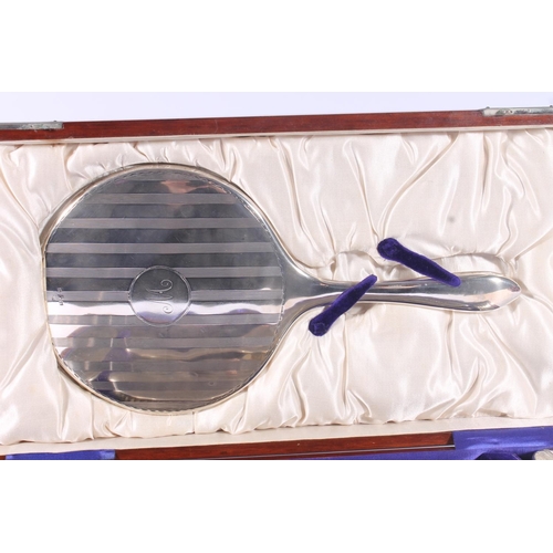 16 - Geo.V silver dressing table set, of four brushes, hand mirror and comb, all with lined engine turned... 