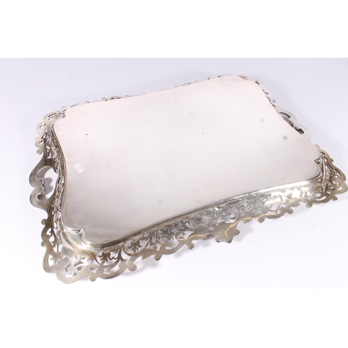 17 - Large Victorian silver plated serving tray, the scrolled acanthus handles between a pierced foliate ... 