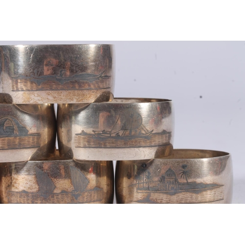 47 - Set of six Iraqi white metal Niello napkin rings decorated with river and landscape scenes.